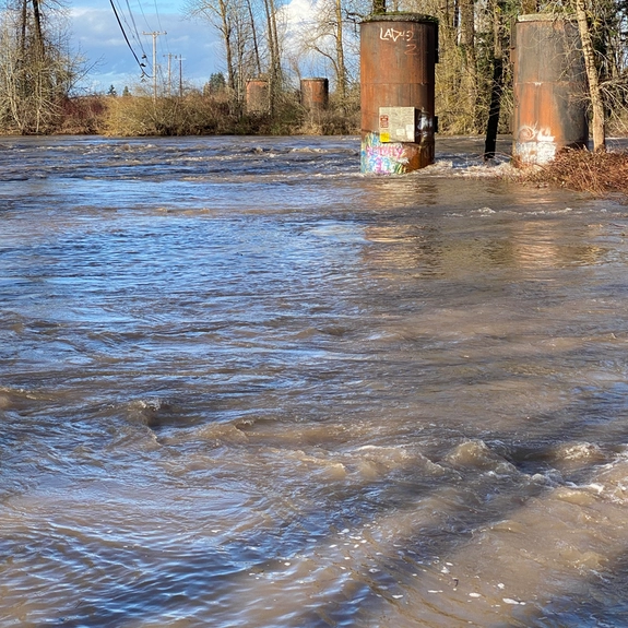 High water flowing through bridge culvert on the North Santiam River during winter conditions