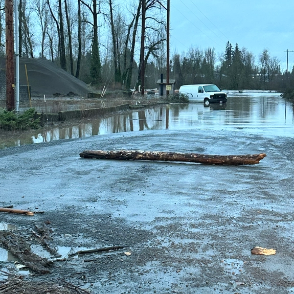 Flooded access road near the North Santiam River after heavy rain in Oregon